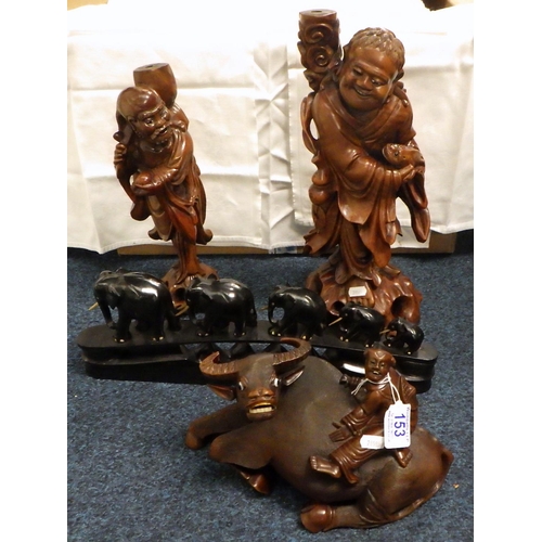 153 - A Chinese carved wood water buffalo together with two similar carved figures and a set of carved ele... 