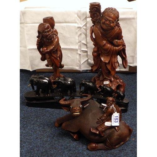 153 - A Chinese carved wood water buffalo together with two similar carved figures and a set of carved ele... 
