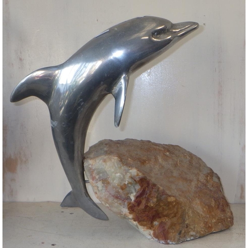 2 - A Chrome plated dolphin attached a a heavy onyx rock 40cm tall.