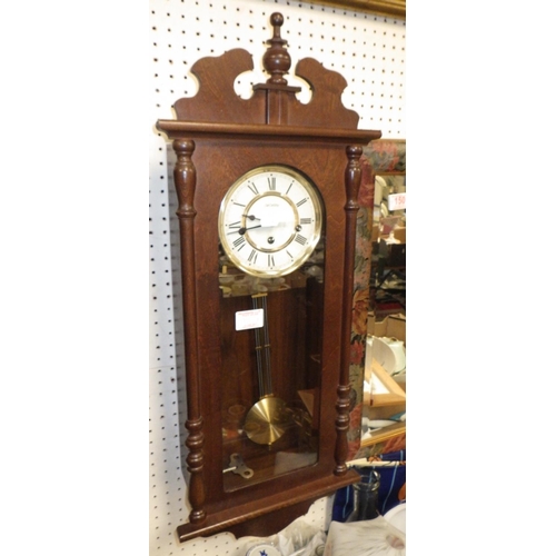 150 - Two large framed bevelled mirrors together with a modern wall clock (3).