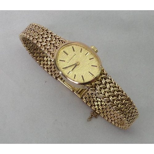 466 - A Longines ladies bracelet watch having a manual wind movement in a 9ct gold oval case with integral... 