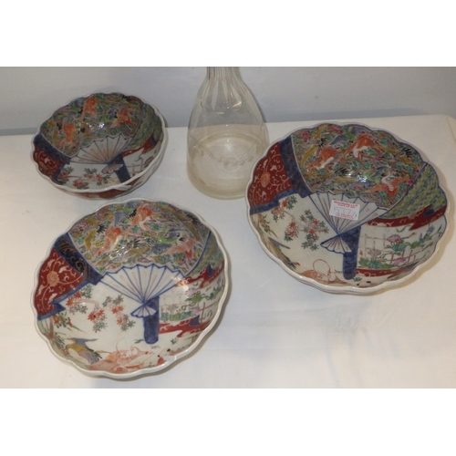 537 - Three graduated Imari bowls together with a decanter