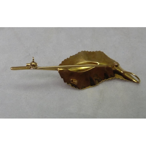 362 - A leaf brooch set with three pearls.  Yellow metal marked k18.  56mm long.