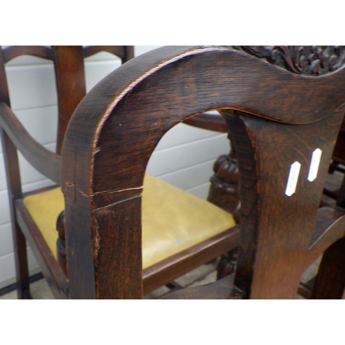 608 - A 1930's carved oak draw leaf table and six chairs, incl  one carver