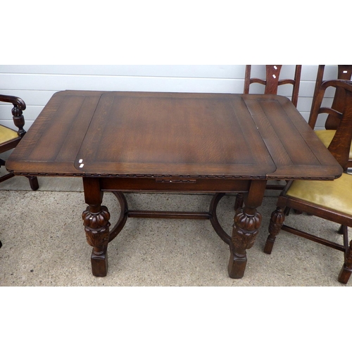 608 - A 1930's carved oak draw leaf table and six chairs, incl  one carver