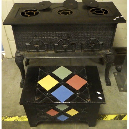 626 - A decorated metal stove with three ring top on cabriole legs, left ring damaged, 87cm wide together ... 