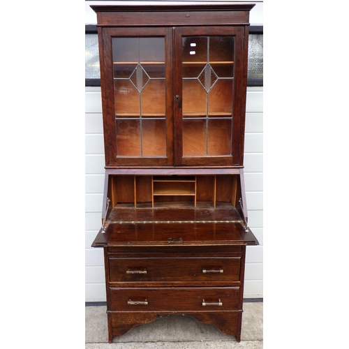 652 - A 1930's oak bureau bookcase with leaded glass doors, (a/f) 79cm wide