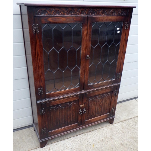 713 - A J.C linenfold panelled oak side cabinet with leaded glass doors, 99cm wide