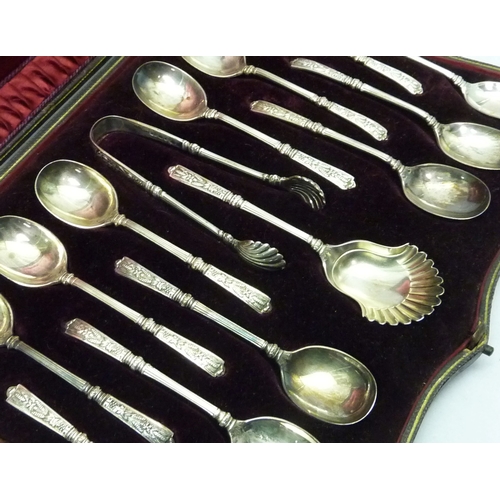 416 - A Victorian silver cased set of twelve silver teaspoons together with matching sugar tongs and caddy... 