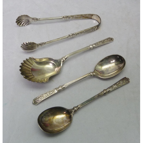 416 - A Victorian silver cased set of twelve silver teaspoons together with matching sugar tongs and caddy... 