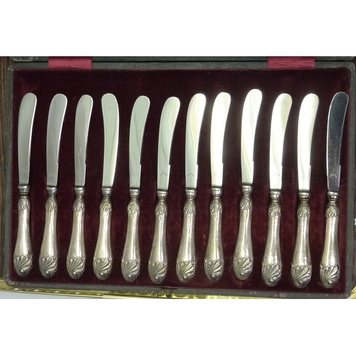 419 - A cased set of twelve silver handled butter knives; a cased gent's hair brush and comb set, silver b... 