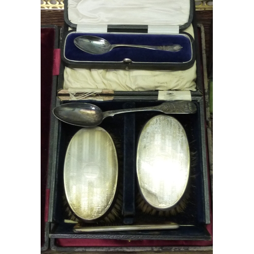 419 - A cased set of twelve silver handled butter knives; a cased gent's hair brush and comb set, silver b... 