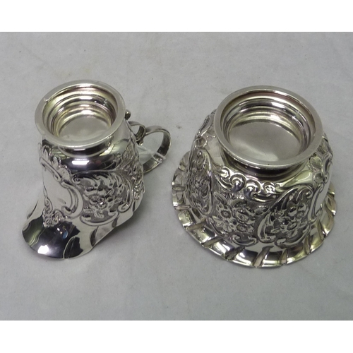 424 - A Victorian repousse decorated silver cream jug and matching sugar bowl, Chester 1900.  Cream jug 65... 