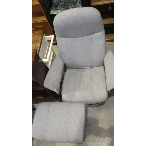 860 - A stressless grey chair and stool af stained.