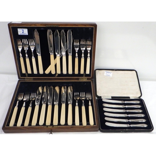 2 - A cased set of silver plate and ivorine fish cutlery; a cased set of silver handled butter knives (2... 