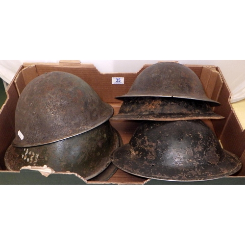 35 - Six tin helmets