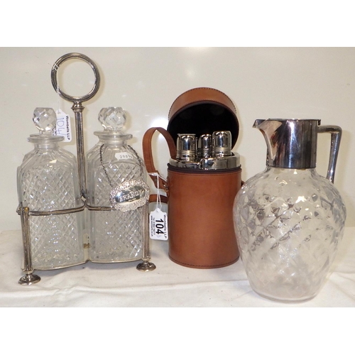 104 - A Silver plated four decanter holder together with a plated  jug (repairs) and a three bottle picnic... 