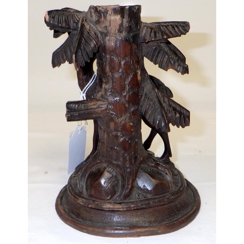 204 - A carved Black Forest type candlestick 18cm tall