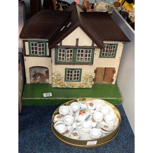 212 - A dolls house together with dolls tea ware and a group of dolls and teddy bears in a case (3)