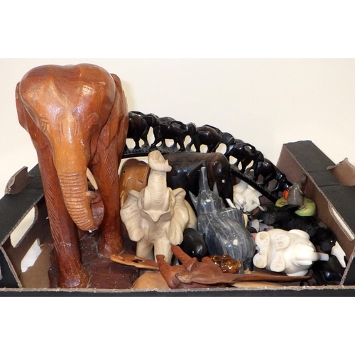 221 - A collection of carved wooden & ceramic elephants