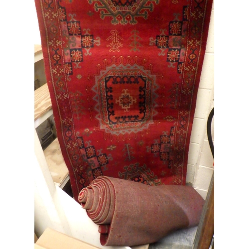 939 - A long machine made red ground stair carpet, wear