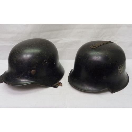 407 - A German WWII style steel helmet shell with non-pattern liner; a German WWII style police / fire hel... 