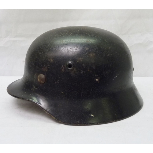 407 - A German WWII style steel helmet shell with non-pattern liner; a German WWII style police / fire hel... 