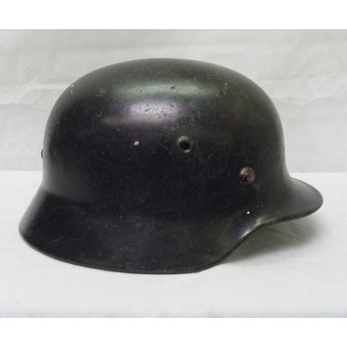 407 - A German WWII style steel helmet shell with non-pattern liner; a German WWII style police / fire hel... 