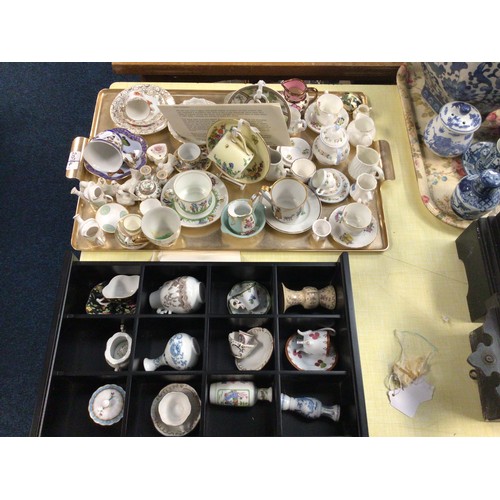 207 - Two trays of various glass perfume bottles, vase, paperweight, various miniature tea cups & saucers ... 