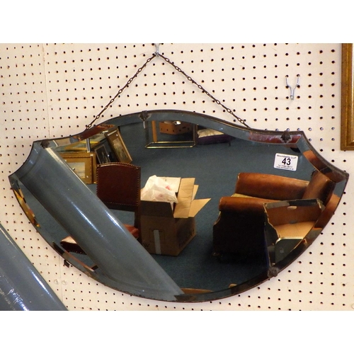 43 - A shaped bevelled frameless mirror af foxing