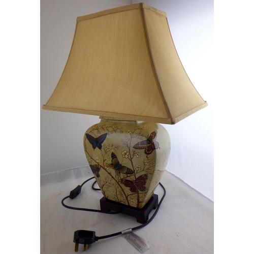 81 - A Mandarin Arts Ltd table lamp together with a pair of candlesticks and a London Clock Company mantl... 