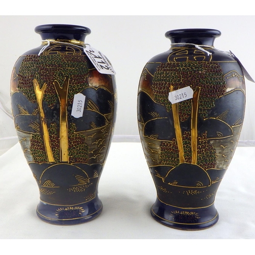 112 - A pair of Oriental vases 22cm tall