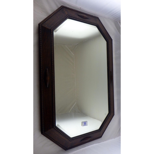 50 - An oak framed bevelled mirror together with three large prints (4)