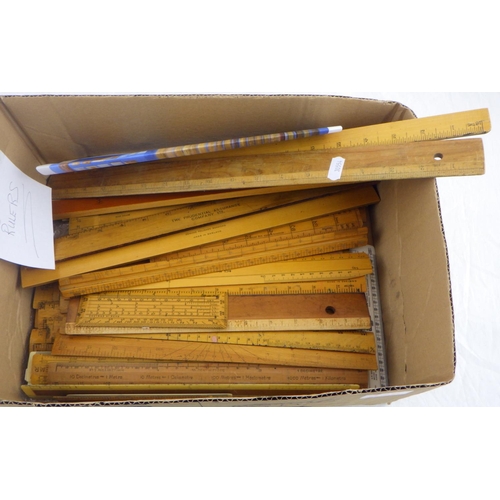 115 - A collection of approximately 50 wooden rulers.