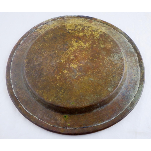 98 - A plate bearing Islamic script design etc, brass and white metal. 27.5cm
