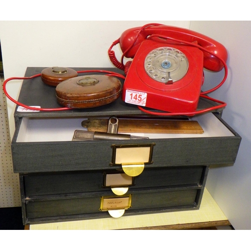 145 - A GPO model 746 rotary dial telephone in red; a set of stationery drawers with contents.  (2)