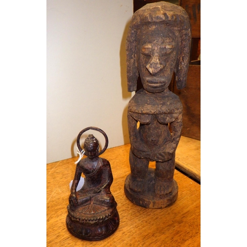 181 - A small cast buddha together with a carved crocodile, carved figure and a painting of Ganesha  woode... 