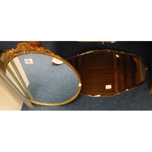 186 - A Frameless bevelled mirror together with a cast metal mirror (2)