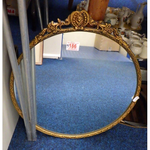 186 - A Frameless bevelled mirror together with a cast metal mirror (2)