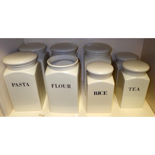 320 - Eight Habitat kitchen storage jars, white glazed potteryof square section with script in English, on... 