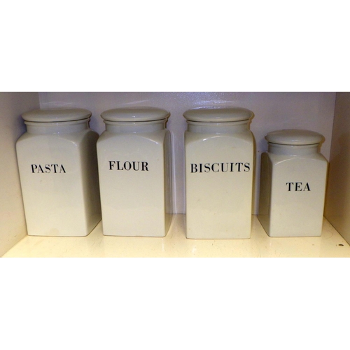 320 - Eight Habitat kitchen storage jars, white glazed potteryof square section with script in English, on... 