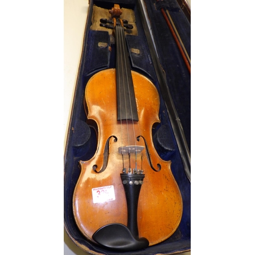 339 - A violin in a leather case, together with a bow.