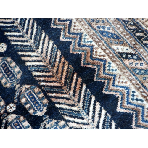 765 - A blue ground rug with three central diamond design, 215cm x 147cm