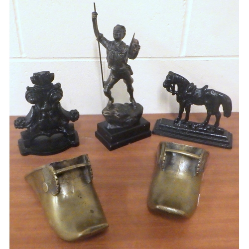 802 - Two cast door stops together with a pair of metal boots and a cast figure (5)