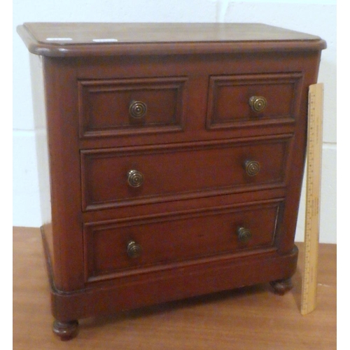 810 - A miniature chest of drawers