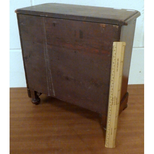 810 - A miniature chest of drawers