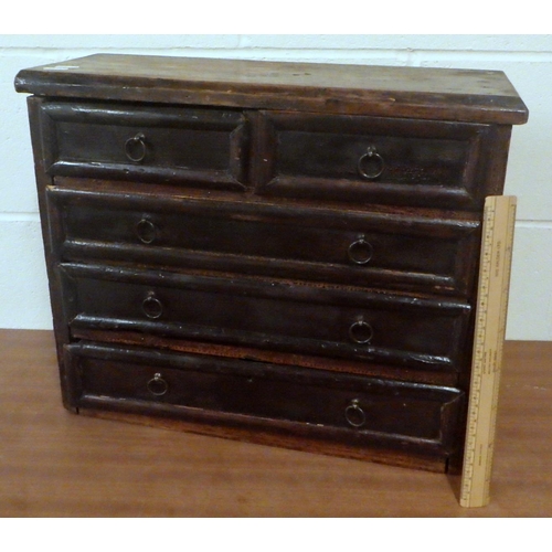 812 - A miniature chest of drawers