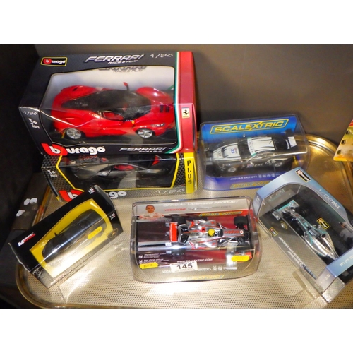 145 - A group of die cast vehicles, Burago, Scalextric etc (9)