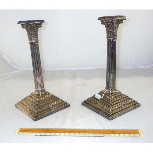 167 - A pair of Silver plated Corinthian column candlesticks 27cm tall