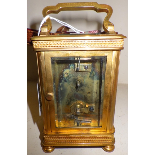 293 - A Brass cased carriage clock in original carry case